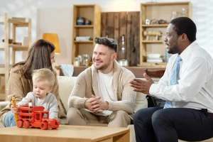 A family discussing with a professional in a cozy living room.