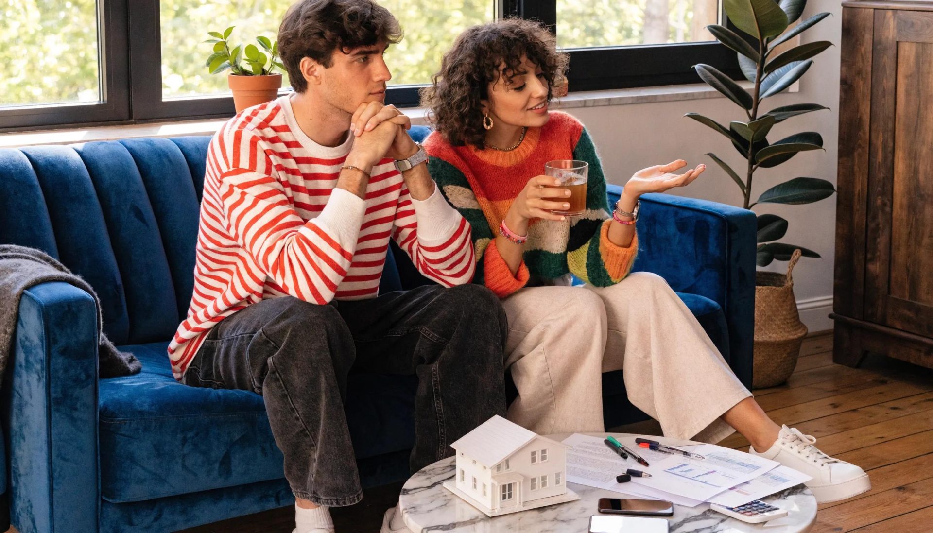 Couple exploring mortgage options while reviewing documents in a bright living room